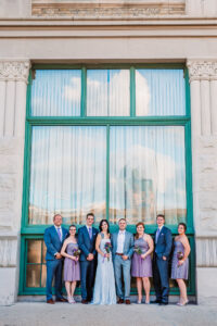 bridal party in front of window