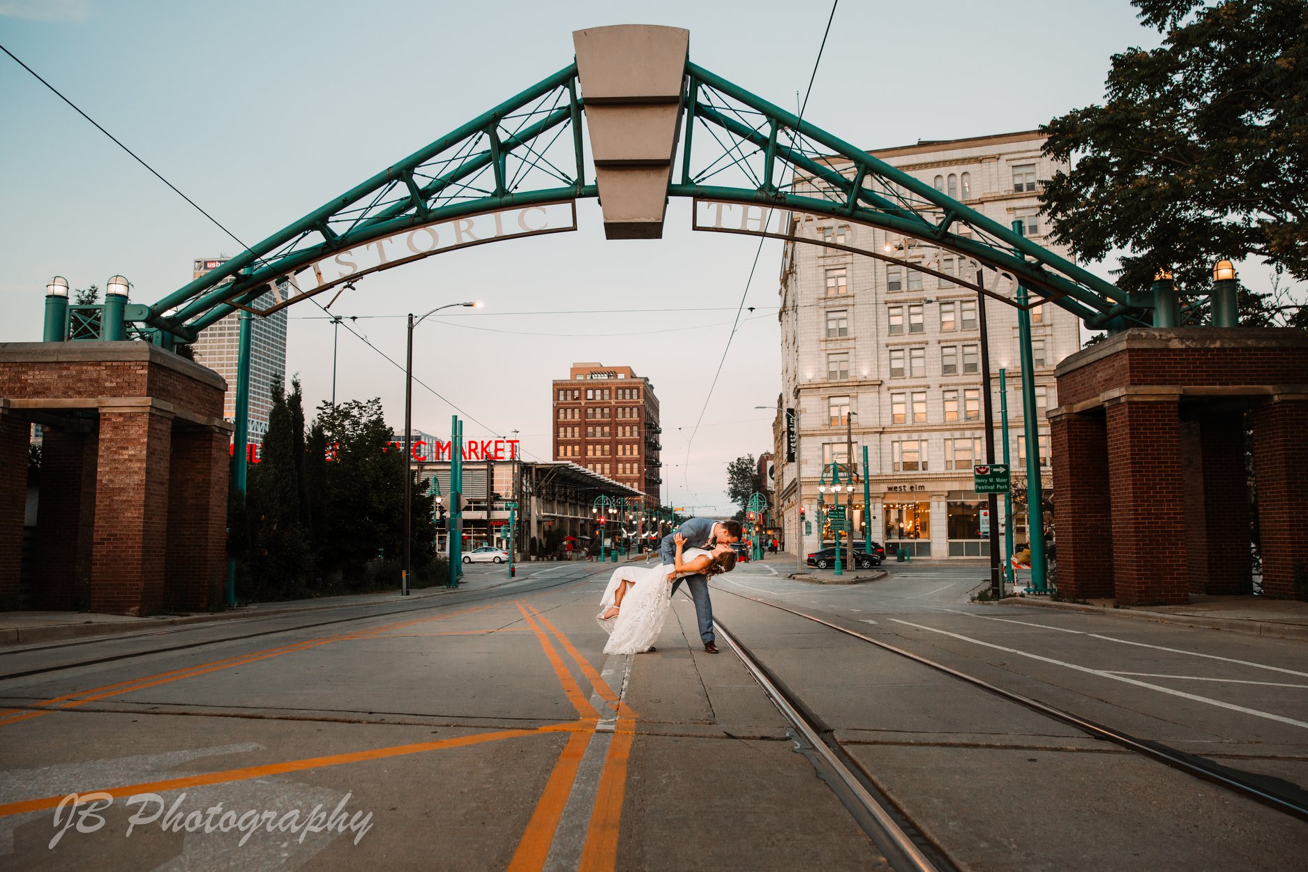 bride and groom kiss in the middle of the street in milwaukees third ward