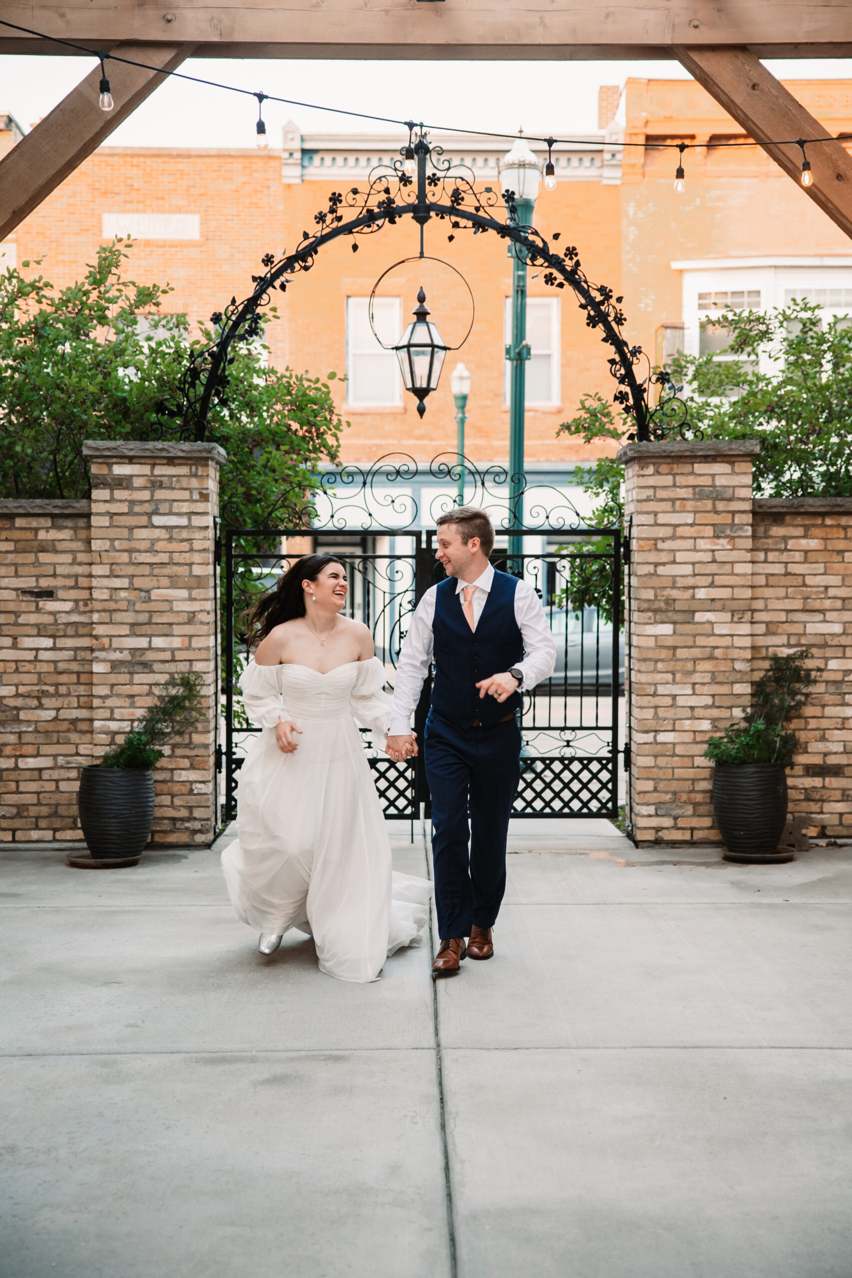 couple running through the courtyard at mercantile hall