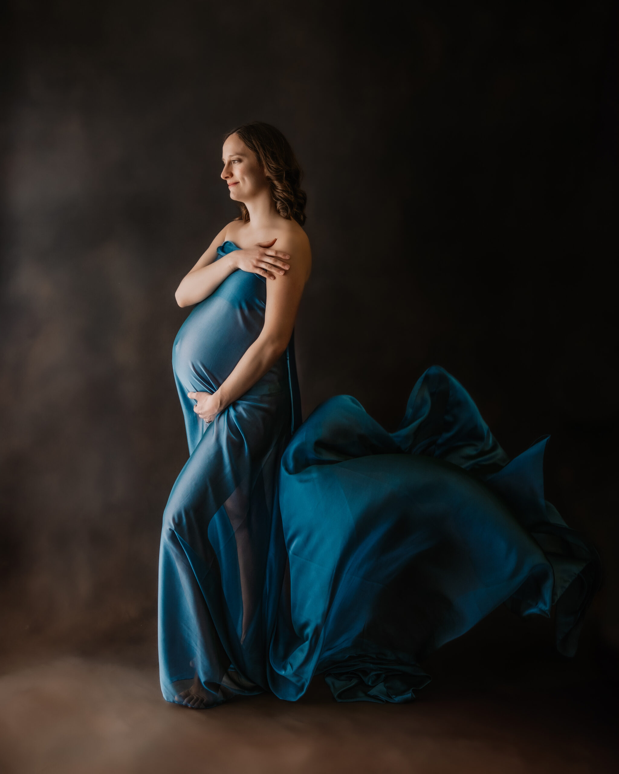 pregnant mom shows off the belly in flowing fabric